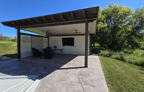 insulated patio cover with two TV walls and side wind-break wall in Big Bend